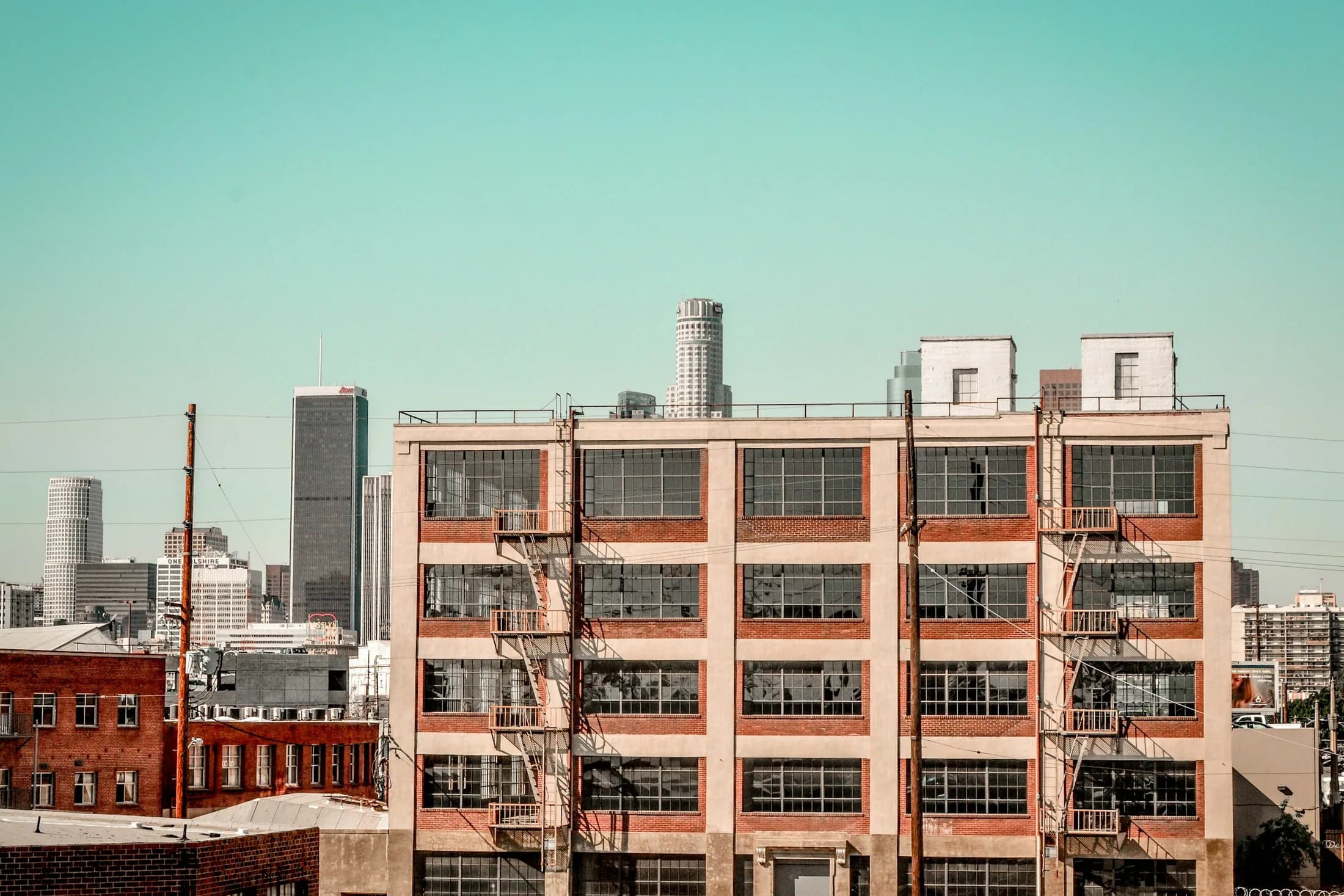Industrial buildings in Los Angeles’ Arts District with the Downtown skyline beyond.