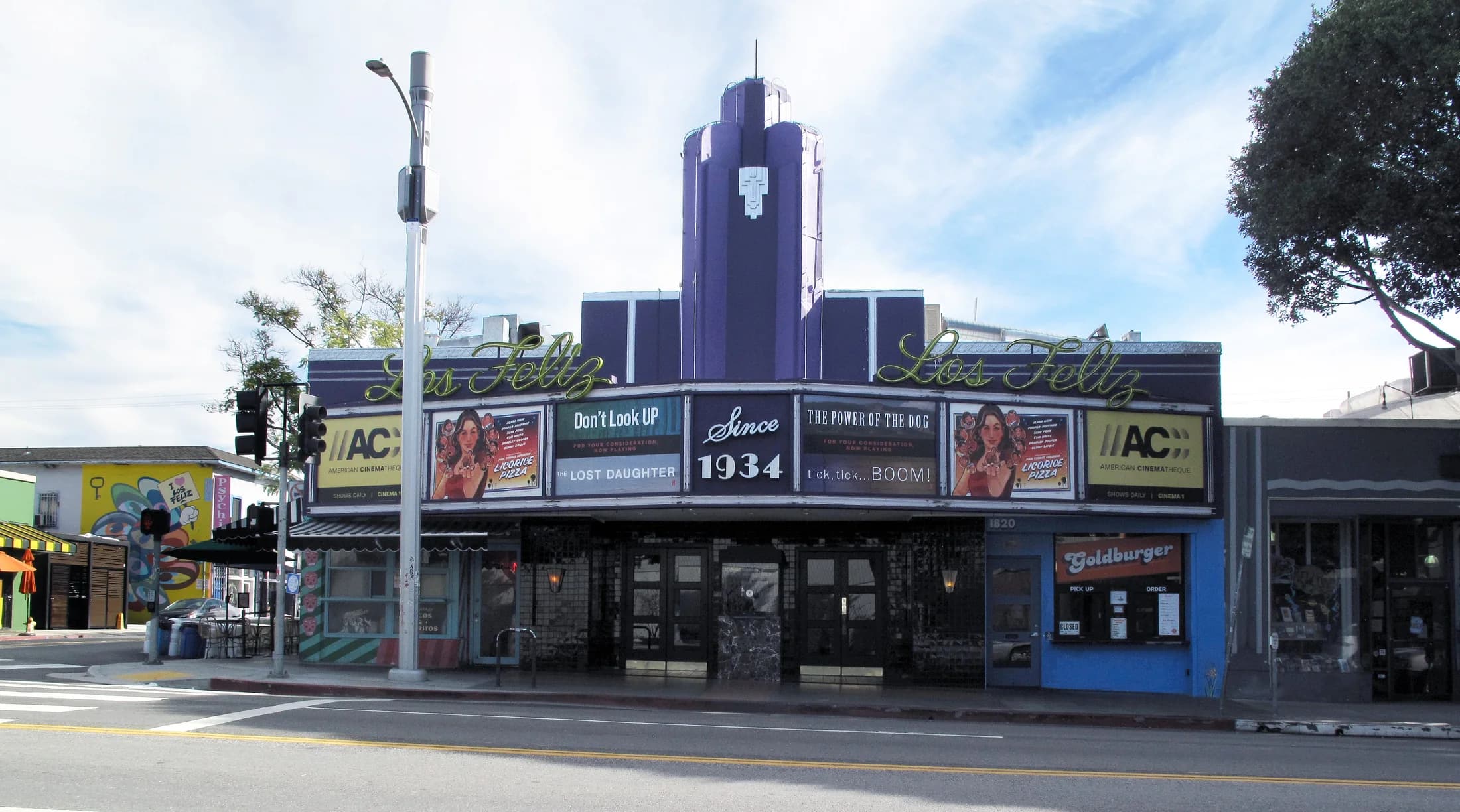The purple Art Deco facade and neon lettering of Los Feliz Theatre on Vermont Avenue.